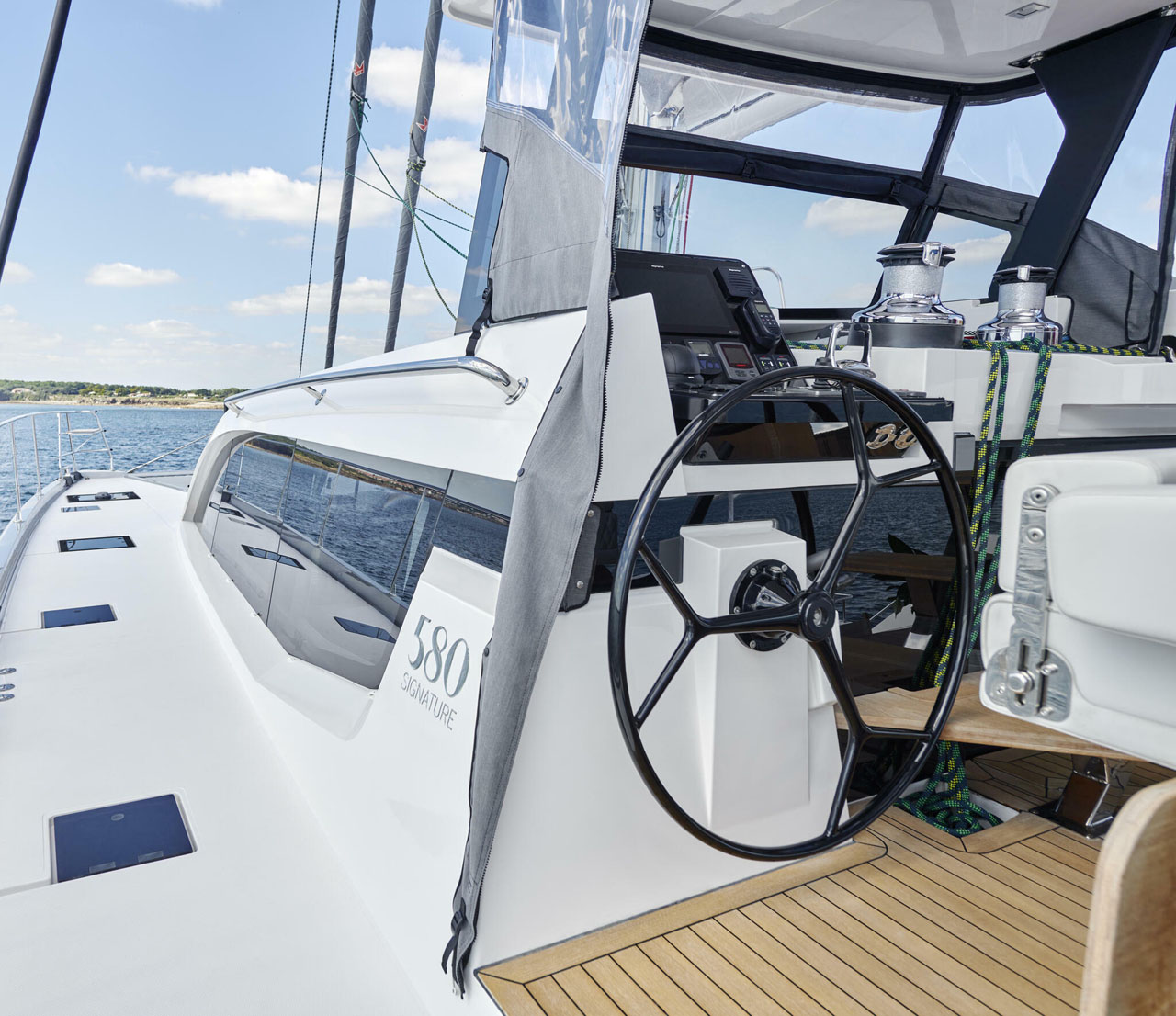 Sleek yacht steering console with a view of the ocean, displaying modern design and luxurious sailing experience.